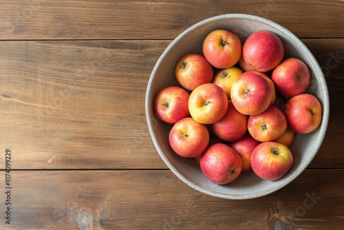 Fruit salad in a bowl on a wooden surface shot from above