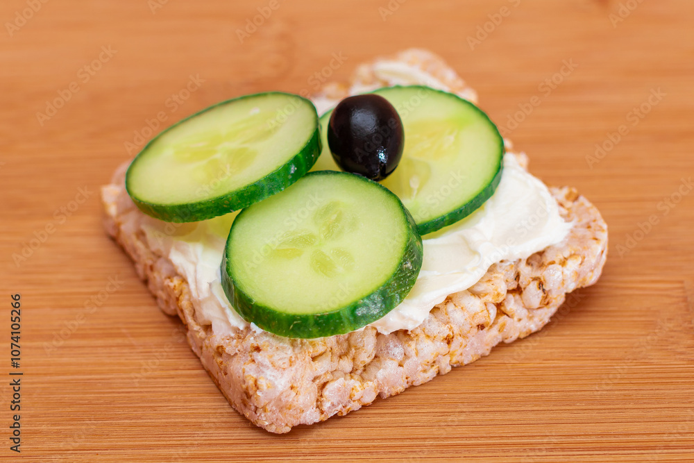 Rice Cake Sandwich with Fresh Cucumber, Cream Cheese and Olives on Bamboo Cutting Board. Easy Breakfast. Diet Food. Quick and Healthy Sandwiches. Crispbread with Tasty Filling. Healthy Dietary Snack Rice Cake Sandwich with Fresh Cucumber, Cream Cheese and Olives on Bamboo Cutting Board. Easy Breakfast. Diet Food. Quick and Healthy Sandwiches. Crispbread with Tasty Filling. Healthy Dietary Snack