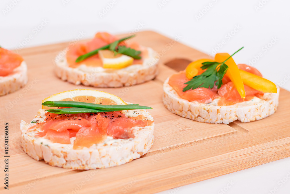 Rice Cake Sandwiches with Fresh Salmon, Cucumber, Lemon and Greens on Bamboo Cutting Board. Diet Food. Quick and Healthy Sandwiches. Crispbread with Fresh Fillings. Healthy Dietary Snacks Rice Cake Sandwiches with Fresh Salmon, Cucumber, Lemon and Greens on Bamboo Cutting Board. Diet Food. Quick and Healthy Sandwiches. Crispbread with Fresh Fillings. Healthy Dietary Snacks