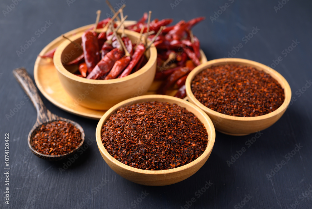 Red chili powder in bowl on black background, Food ingredient Red chili powder in bowl on black background, Food ingredient