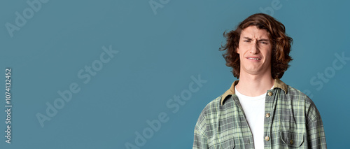 Obraz na płótnie Young guy with disgusted expression on turquoise background