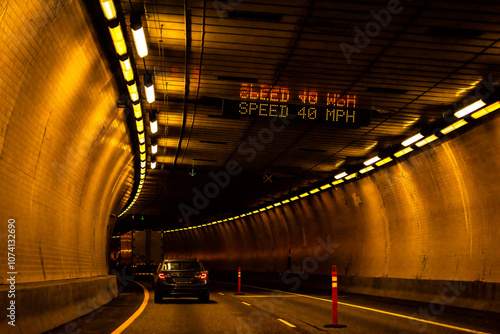 Tunnel inside driving point of view near Glenwood Springs, Colorado with lights path illuminated in dark passage interstate i70 highway photo