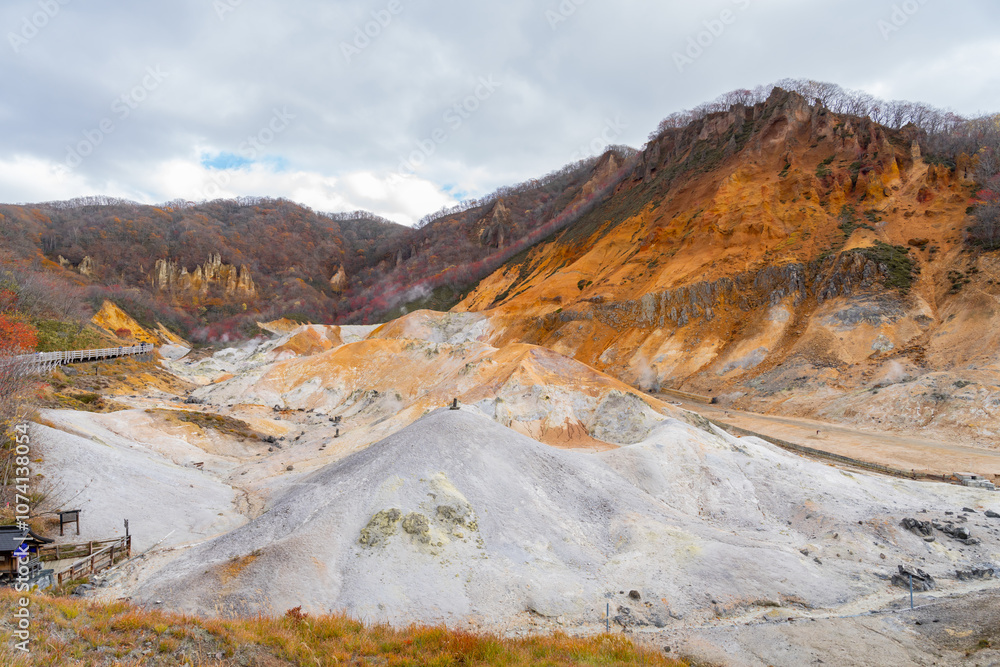 Obraz premium The landscape of a volcano, Jigokudani or Hell Valley is a spectacular valley and a main hot spring waters source of Noboribetsu Onsen Town: Noboribetsu, Hokkaido, Japan, autumn leaves.