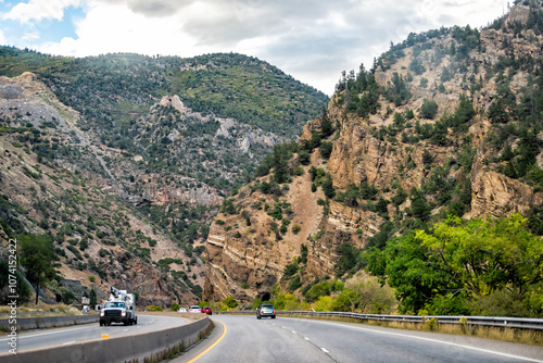 Glenwood Springs, Colorado interstate highway 70 road with cars driving by ski resort town in summer by Glenwood canyon mountains