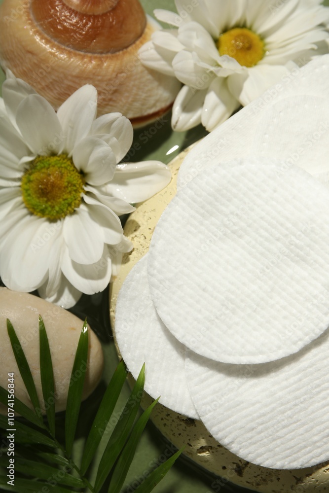 Flat lay composition with cotton pads on green table Flat lay composition with cotton pads on green table