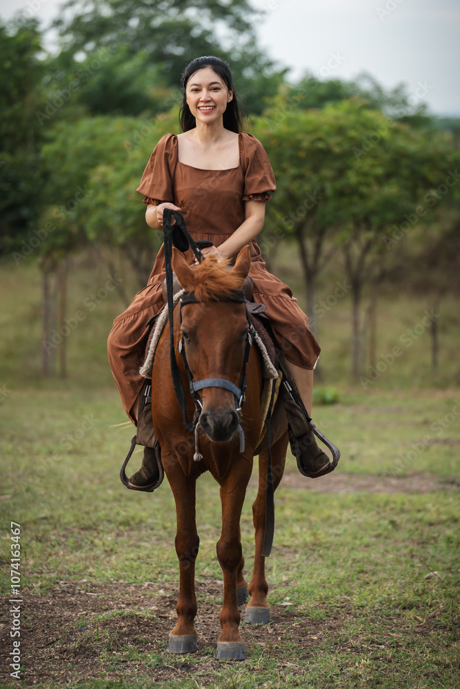 Fototapeta premium happy woman riding horse on meadow field