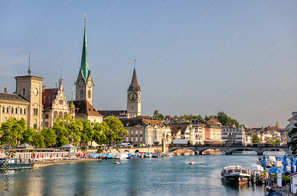 Fototapeta premium Zurich, Switzerland - July 26, 2024: The waterfront and old town at the mouth of the Limmat Riverl in Zurich Switzerland 