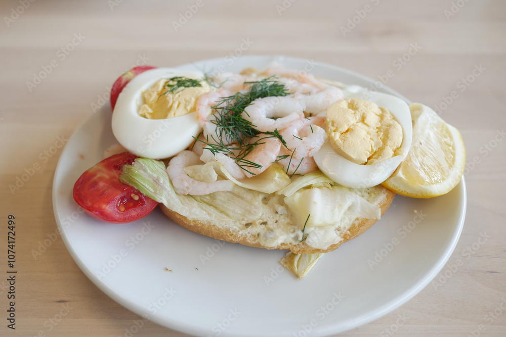 A Delicious and Savory Shrimp and Egg Sandwich Presented on a Plate with Fresh Vegetables A Delicious and Savory Shrimp and Egg Sandwich Presented on a Plate with Fresh Vegetables