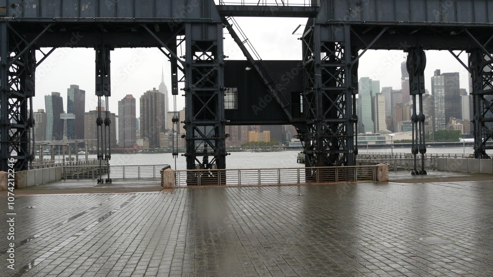 New York City waterfront skyline, Manhattan midtown, riverfront skyscrapers by East river water. Waterside cityscape view from Gantry Plaza dock pier, Long Island, Queens. United States architecture. New York City waterfront skyline, Manhattan midtown, riverfront skyscrapers by East river water. Waterside cityscape view from Gantry Plaza dock pier, Long Island, Queens. United States architecture.
