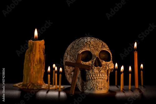 Day of the dead skull with wooden cross and swirling fog lit with candles photo