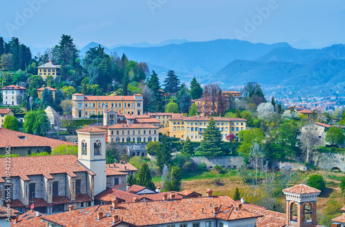 Bergamo Alta against the green San Vigilio Hill and Bergamasque Alps, Italy