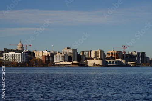 City landscape photo of Madison, Wisconsin capitol and city buildings from Olin park.