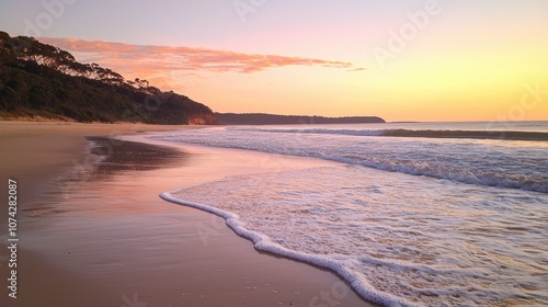 Serene Sunset Over Calm Beach with Gentle Waves and Soft Sand, Showcasing Vibrant Colors and Tranquil Atmosphere Perfect for Relaxation and Nature Lovers