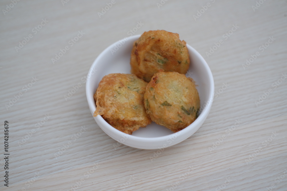 Perkedel is fried patties, made of ground potatoes and minced meat and vegetables Perkedel is fried patties, made of ground potatoes and minced meat and vegetables