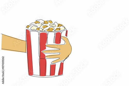 National Popcorn Day. One single line drawing of hand grabbing stripped pop corn paper bucket contain sweet popcorn. Delicious snack to accompany watching movie. Continuous line draw vector graphic