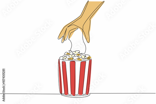 Happy National Popcorn Day. Single continuous line drawing of person hand picking caramel flavor popcorn up from stripped pop corn paper bucket. Food snack concept. One line draw vector illustration