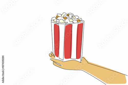 National Popcorn Day. One continuous line drawing of person hand holding stripped paper bucket contain salted popcorn. Food snack to watch a movie concept. Single line draw vector graphic illustration