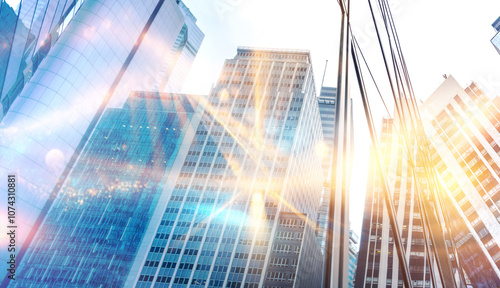 Wallpaper Mural A low angle view of a city skyline with tall buildings and bright sunlight reflecting off the glass windows. Torontodigital.ca