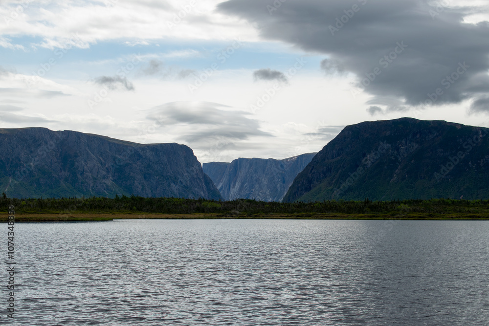 Aboard the ferry on Western Brook Pond, the breathtaking fjord and surrounding landscapes unfold, offering a tranquil and scenic journey through Gros Morne National Park. Aboard the ferry on Western Brook Pond, the breathtaking fjord and surrounding landscapes unfold, offering a tranquil and scenic journey through Gros Morne National Park.
