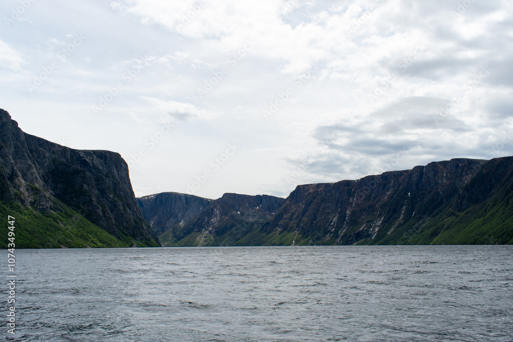On the ferry cruising Western Brook Pond, travelers can enjoy breathtaking vistas of the towering fjord and untouched natural beauty offering a tranquil and memorable adventure. On the ferry cruising Western Brook Pond, travelers can enjoy breathtaking vistas of the towering fjord and untouched natural beauty offering a tranquil and memorable adventure.