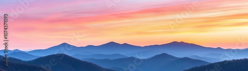 Mountains under a vibrant sunrise sky with hues of pink, orange, and purple, with gentle cloud layers adding depth to the breathtaking scene