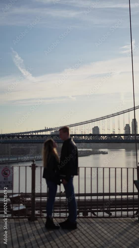 Urban Lovers Are Strolling Hand in Hand by the River Under a Beautiful Clear Sky Urban Lovers Are Strolling Hand in Hand by the River Under a Beautiful Clear Sky