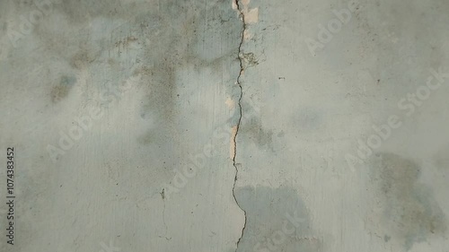 the house wall is cracked. The crack was caused by extreme weather