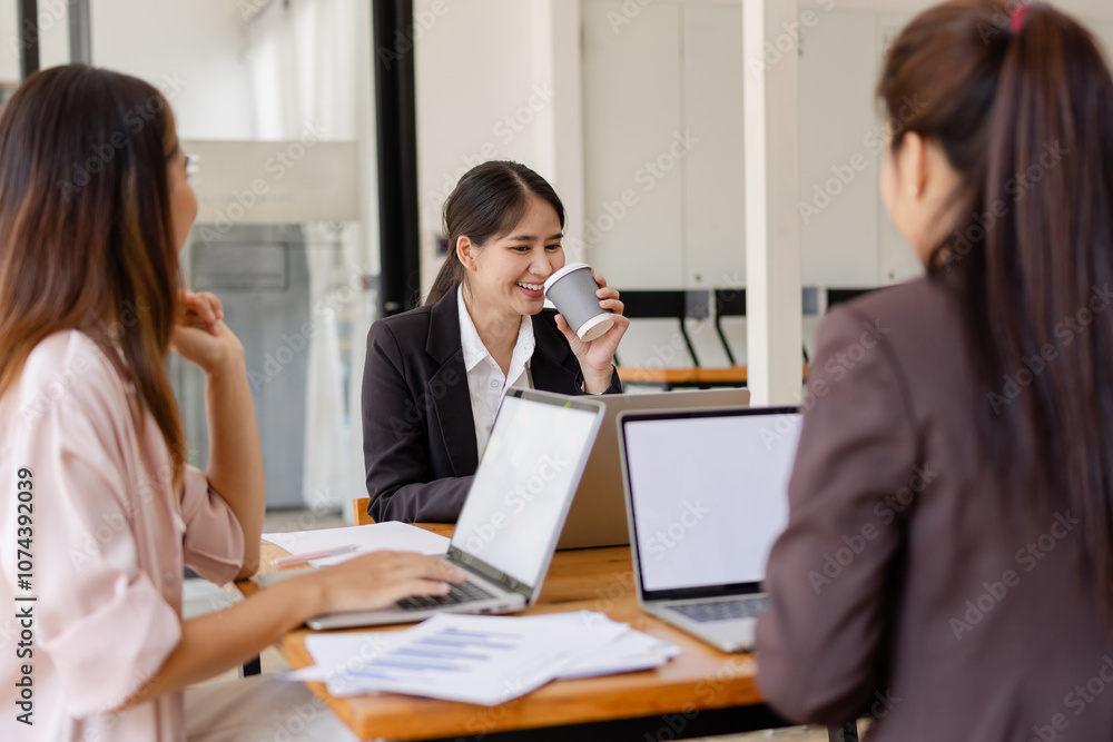 Fototapeta premium Asian businesswoman teamwork working on laptop with finances analysis report at desk in office, business financing, accounting banking, Team of creative and business planning, 