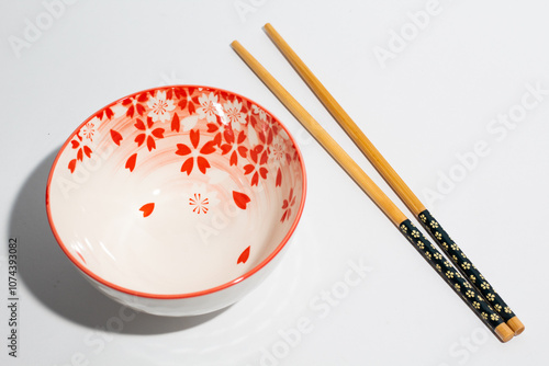 Floral pattern of chinese bowl and chopsticks on white background