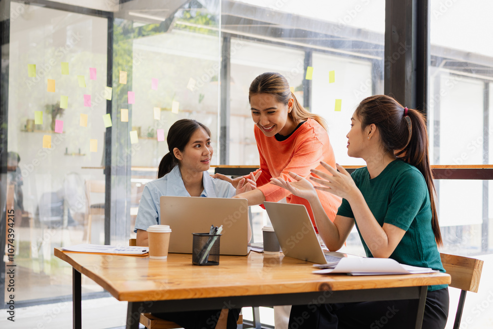 Excited Asian businesswoman team working together in office, About successful startup projects concept. Excited Asian businesswoman team working together in office, About successful startup projects concept.