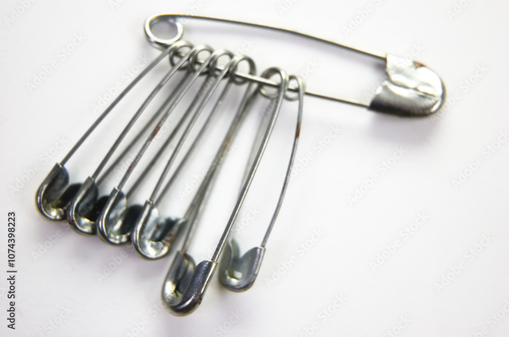 Metal safety pin isolated on white background. Metal safety pin isolated on white background.