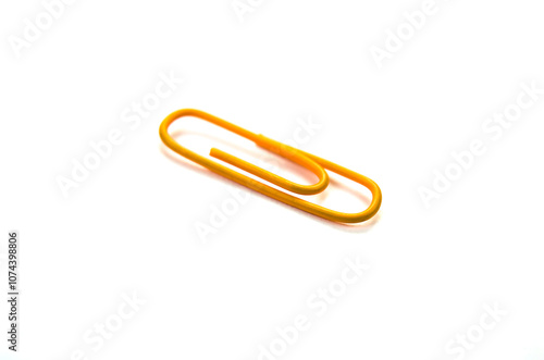 Orange paper clip isolated on white background. close up photo