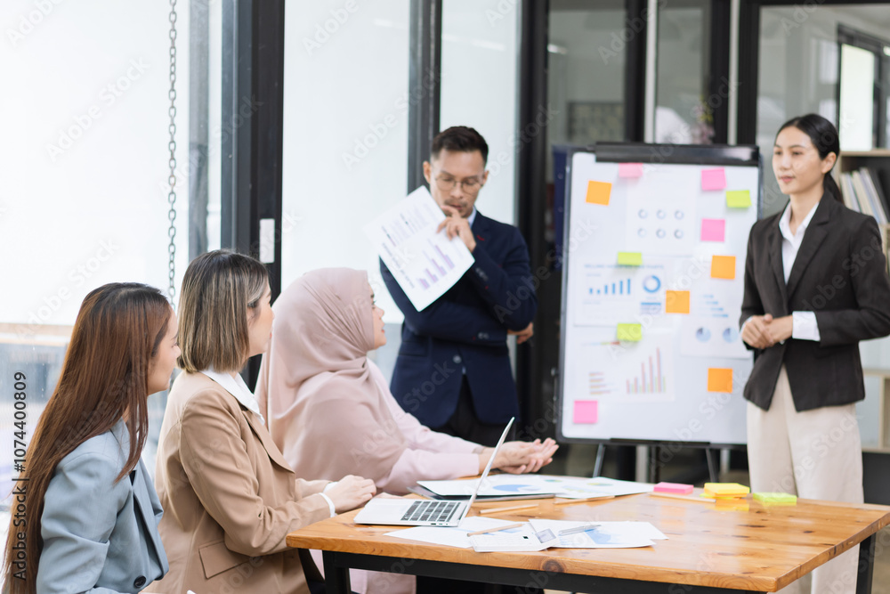 Obraz premium Team of Asian business people and working together in office, Startup projects and business presentation at meeting room.