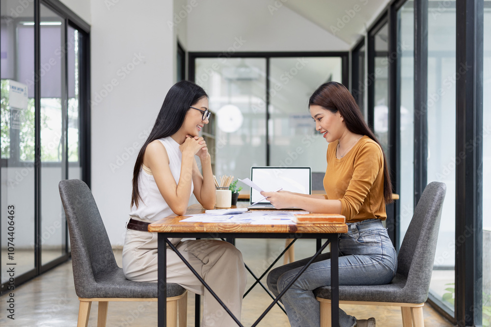 young asian businesswoman working on laptop with finances analysis report at desk in office, business financing, accounting banking, young asian businesswoman working on laptop with finances analysis report at desk in office, business financing, accounting banking,