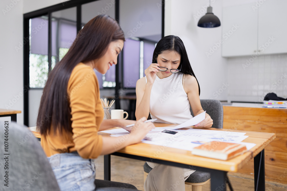 young asian businesswoman working on laptop with finances analysis report at desk in office, business financing, accounting banking, young asian businesswoman working on laptop with finances analysis report at desk in office, business financing, accounting banking,