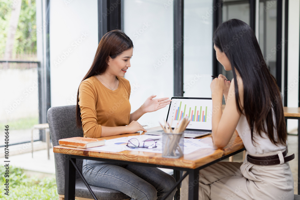 young asian businesswoman working on laptop with finances analysis report at desk in office, business financing, accounting banking, young asian businesswoman working on laptop with finances analysis report at desk in office, business financing, accounting banking,