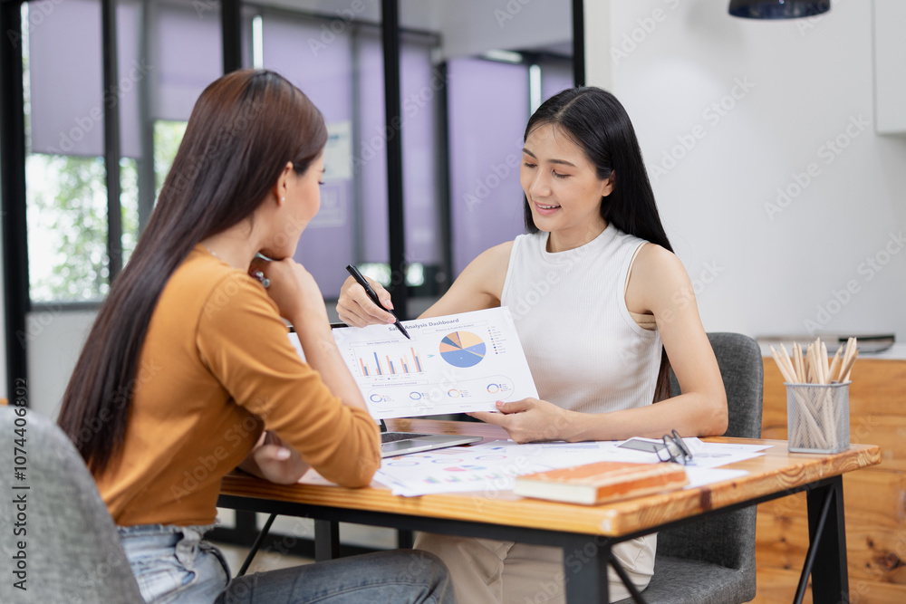 young asian businesswoman working on laptop with finances analysis report at desk in office, business financing, accounting banking, young asian businesswoman working on laptop with finances analysis report at desk in office, business financing, accounting banking,