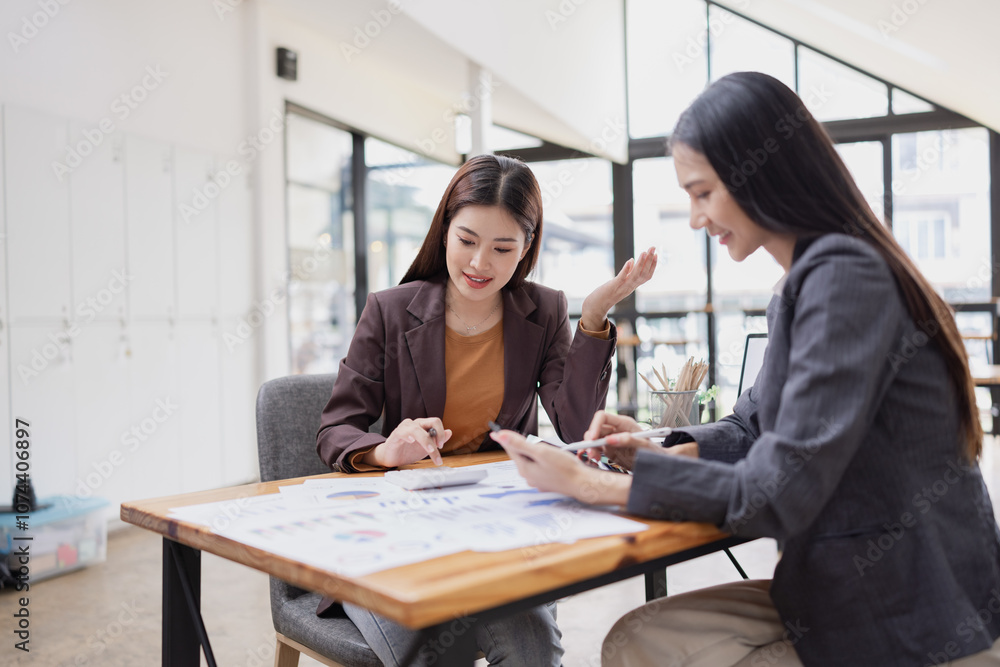 young asian businesswoman working on laptop with finances analysis report at desk in office, business financing, accounting banking, young asian businesswoman working on laptop with finances analysis report at desk in office, business financing, accounting banking,