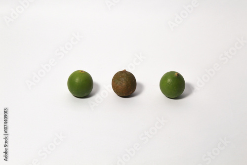 Green lime fruits on isolated white background. Sliced and unsliced. photo