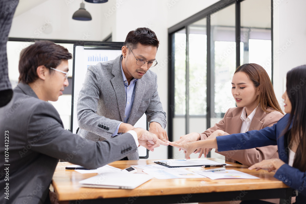 Asian business teamwork working with analysis report and advisor showing plan, Financial analysis and Marketing teamwork concept. Asian business teamwork working with analysis report and advisor showing plan, Financial analysis and Marketing teamwork concept.