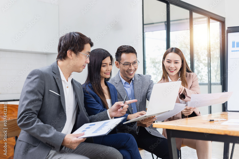 Asian business teamwork working with analysis report and advisor showing plan, Financial analysis and Marketing teamwork concept. Asian business teamwork working with analysis report and advisor showing plan, Financial analysis and Marketing teamwork concept.