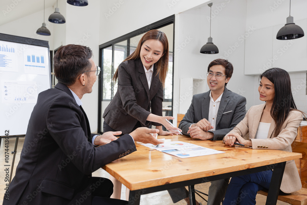 Asian business teamwork working with analysis report and advisor showing plan, Financial analysis and Marketing teamwork concept. Asian business teamwork working with analysis report and advisor showing plan, Financial analysis and Marketing teamwork concept.