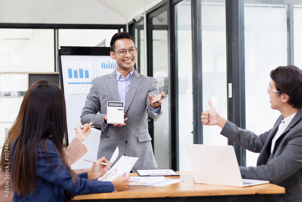 Asian business teamwork working with analysis report and advisor showing plan, Financial analysis and Marketing teamwork concept. Asian business teamwork working with analysis report and advisor showing plan, Financial analysis and Marketing teamwork concept.