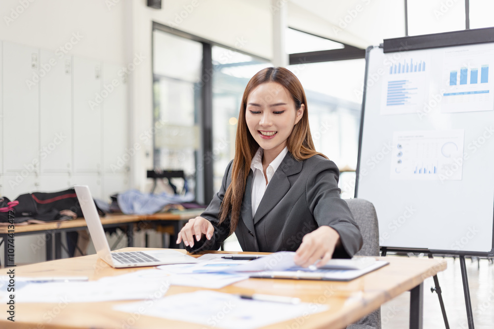 young asian businesswoman working on laptop with finances analysis report at desk in office, business financing, accounting banking, young asian businesswoman working on laptop with finances analysis report at desk in office, business financing, accounting banking,