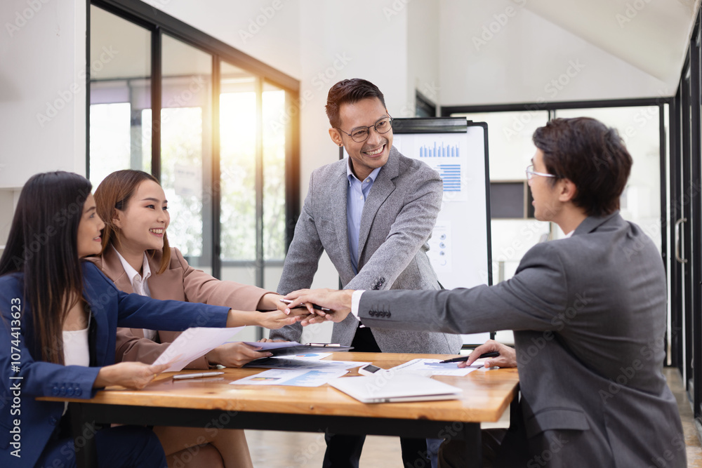 Asian business teamwork working with analysis report and advisor showing plan, Financial analysis and Marketing teamwork concept. Asian business teamwork working with analysis report and advisor showing plan, Financial analysis and Marketing teamwork concept.
