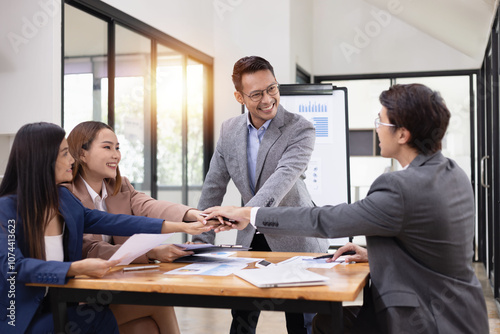 Asian business teamwork working with analysis report and advisor showing plan, Financial analysis and Marketing teamwork concept.