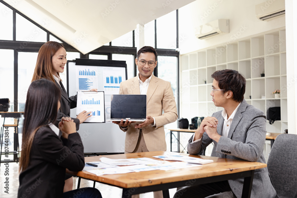 Asian business teamwork working with analysis report and advisor showing plan, Financial analysis and Marketing teamwork concept. Asian business teamwork working with analysis report and advisor showing plan, Financial analysis and Marketing teamwork concept.