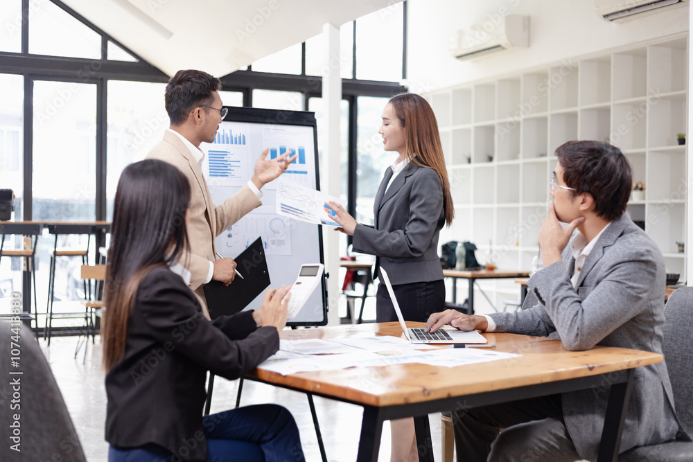 Asian business teamwork working with analysis report and advisor showing plan, Financial analysis and Marketing teamwork concept. Asian business teamwork working with analysis report and advisor showing plan, Financial analysis and Marketing teamwork concept.