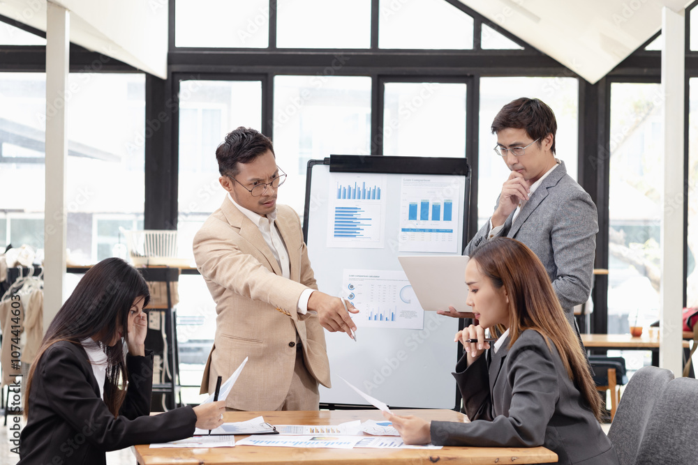 Asian business teamwork working with analysis report and advisor showing plan, Financial analysis and Marketing teamwork concept. Asian business teamwork working with analysis report and advisor showing plan, Financial analysis and Marketing teamwork concept.