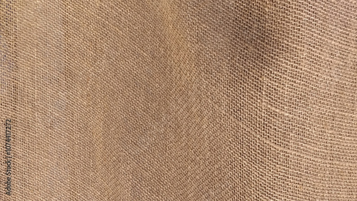 Texture of burlap. Close view of a piece of used brown burlap cloth.